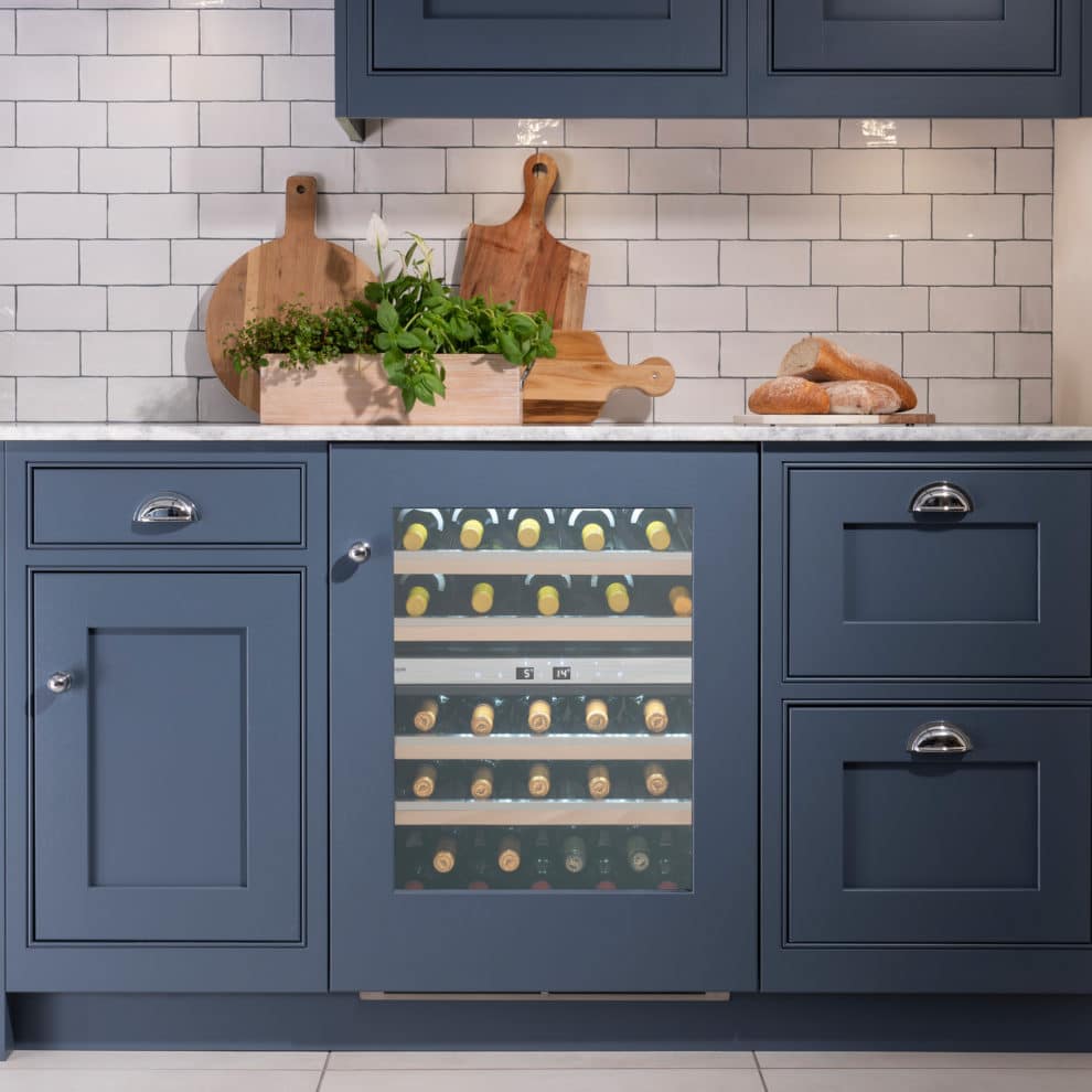 Wine Cooler in blue kitchen with furniture door surround