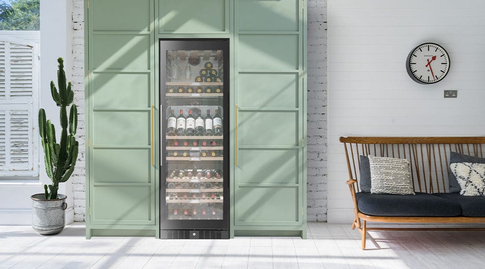 Large freestanding built in wine cooler in green kitchen