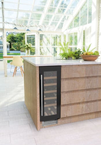 30cm Wine Cooler Single Zone in Black Glass in a green and wood kitchen