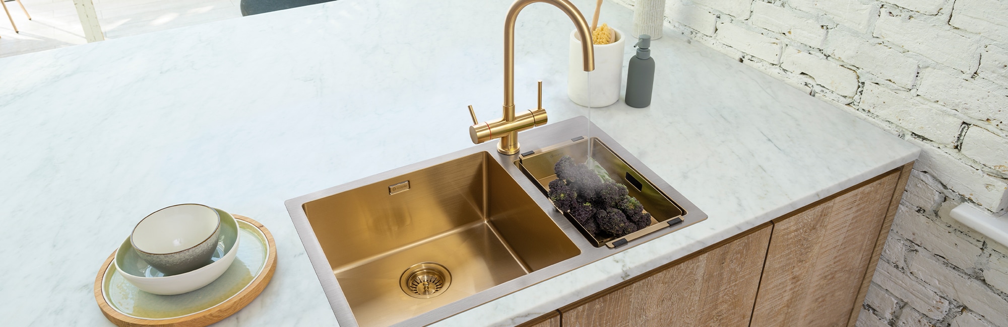 Gold & stainless steel sink with matching gold hot water tap