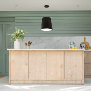 Black island hood in modern wood and green kitchen